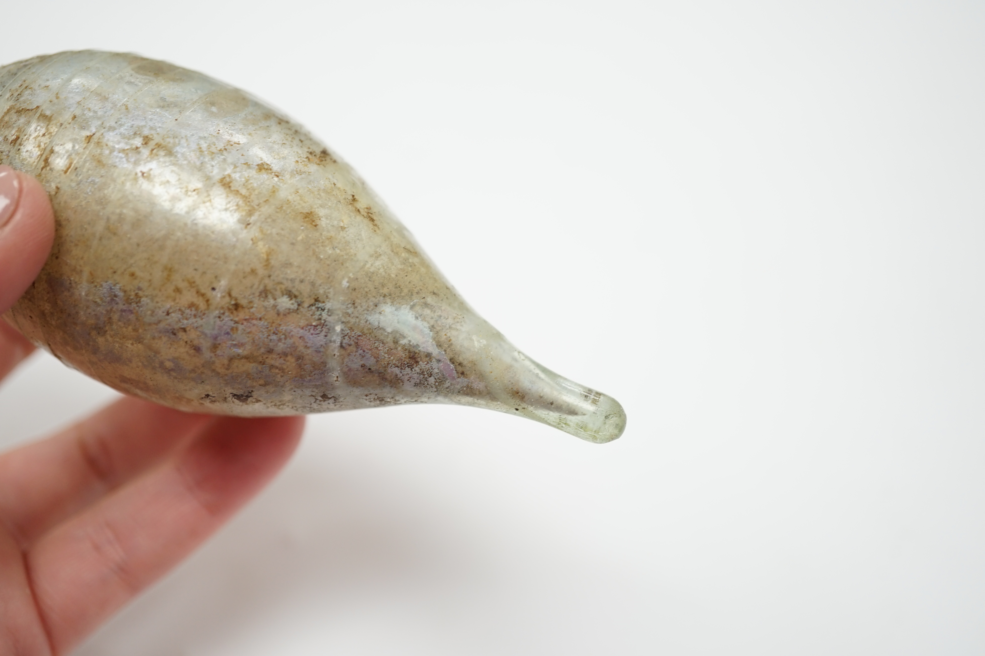A Roman glass unguentarium, with trailed decoration, 14cm. Condition - poor, has a vertical crack from top to bottom